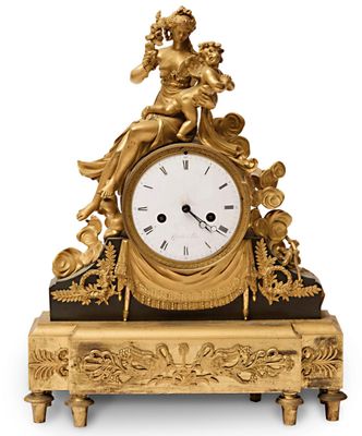une horloge en or surmontée d'une statue