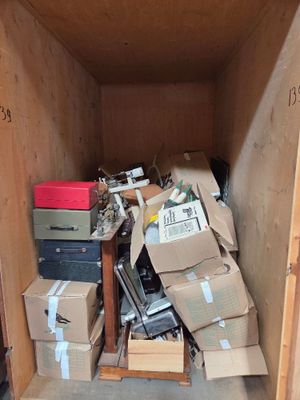 a small wooden box filled with boxes and other items