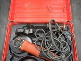 a tool in a red case that is sitting on a table