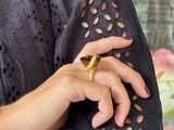 a woman that is holding a ring in her hand