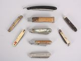 many different types of knives on a white surface