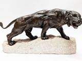 statue of a lion on a rock on a white background