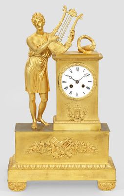 a gold clock with a statue of a woman holding a harp