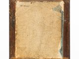 an old picture frame with a piece of paper on top of it