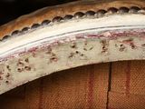 a close up of a chair that has holes in it