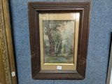 framed painting of a wooded scene with trees and a stream