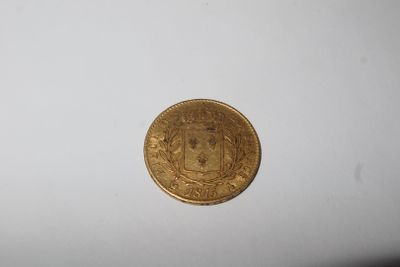 an image of a gold coin on a white surface