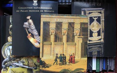 many books that are on a shelf in a library