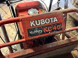 a small red machine that is sitting on the ground