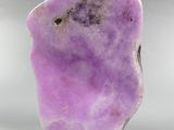 a close up of a purple rock on a white surface