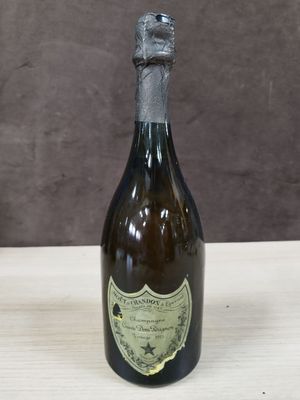 une vieille bouteille de vin posée sur une table en bois