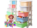 a small child that is sitting in front of a stack of containers