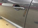 a close up of a car door handle with a sticker on it
