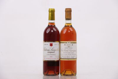 two bottles of wine sitting next to each other on a table