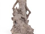 statue of a man and a dog on a rock