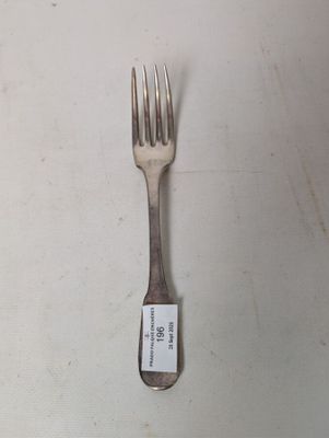 a fork with a tag on it sitting on a table
