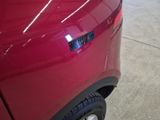 a close up of a red car with a sticker on it