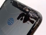 a broken cell phone with a broken screen on it