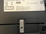 a close up of a black printer with a label on it