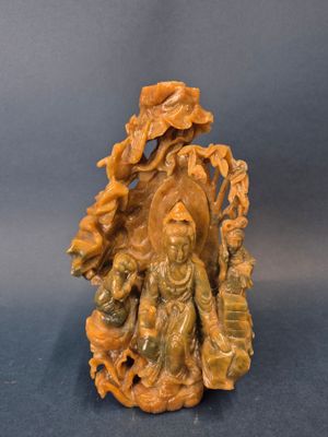 a carved figurine of a woman and child