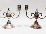 pair of silver plated candlesticks on stands on a white background