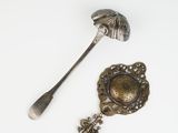 silver spoon and spoon rest on a white surface with a silver spoon and spoon rest on a white surface with a silver spoon and spoon rest on a white surface