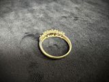 a close up of a gold ring on a black surface