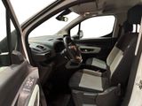 the interior of a small car with the door open and the driver ' s seat down