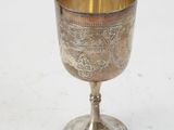 a silver goblet on a white surface with a white background