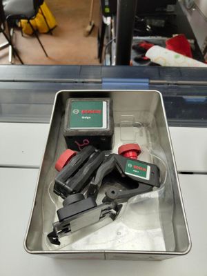 a metal tray with tools in it sitting on a counter