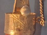 a gold and red fire hydrant with a chain around it