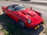 a red car that is parked on the side of the road
