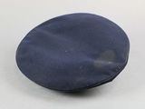a close up of a blue hat on a white surface