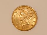 a close up of a gold coin with a woman ' s head on it