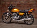 a yellow motorcycle parked in front of a brick wall