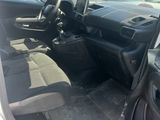 a white car with its door open in a parking lot