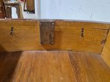 a wooden bench that has a metal latch on it