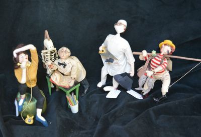 five figurines of people sitting on a chair