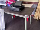 a small table with a laptop on it in a room