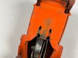 an orange toy car that is sitting on a white surface