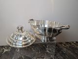 a silver bowl and a silver bowl on a marble table
