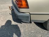 a shadow of a person on the ground next to a car