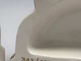 pair of white ceramic cat figurines with numbers on them