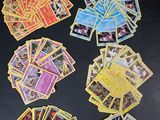 many pokemon cards laid out on a black surface