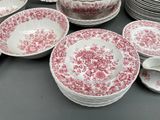 many plates and bowls that are sitting on a table