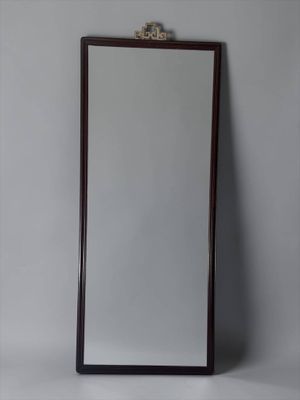 an image of a mirror with a wooden frame on a wall
