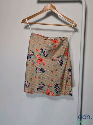 a skirt hanging on a hanger in a room