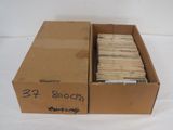 a cardboard box with a lot of books in it