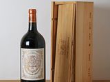 a bottle of wine on a table next to a wooden box