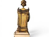 a gold clock with a bird on top of it